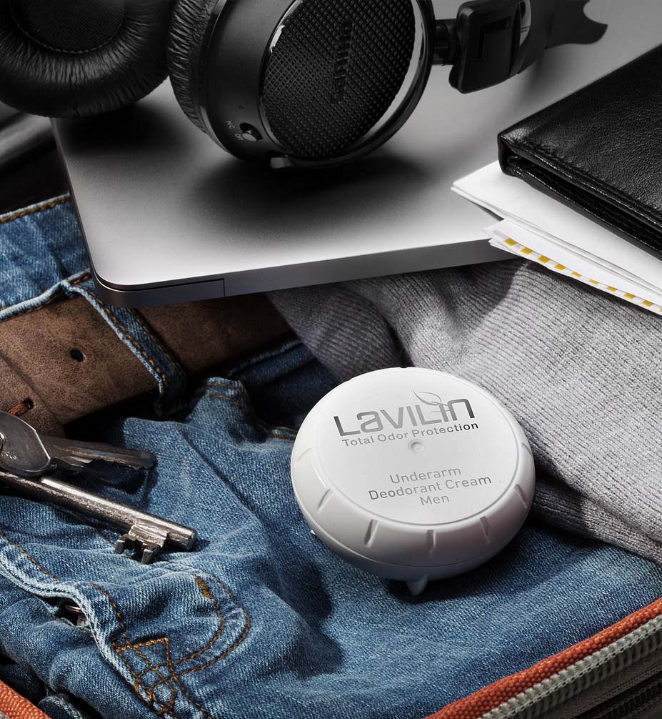 lavilin deodorant cream for men in a suitcase with laptop and headphones