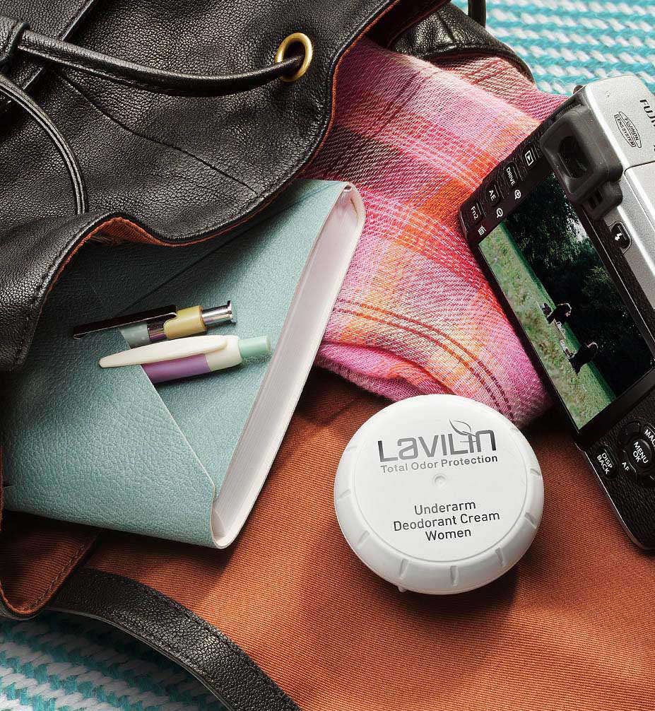 Lavilin cream deodorant for women in a hand bag with diary and camera